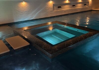 Lit spa and pool at night at the Cahaba Living project